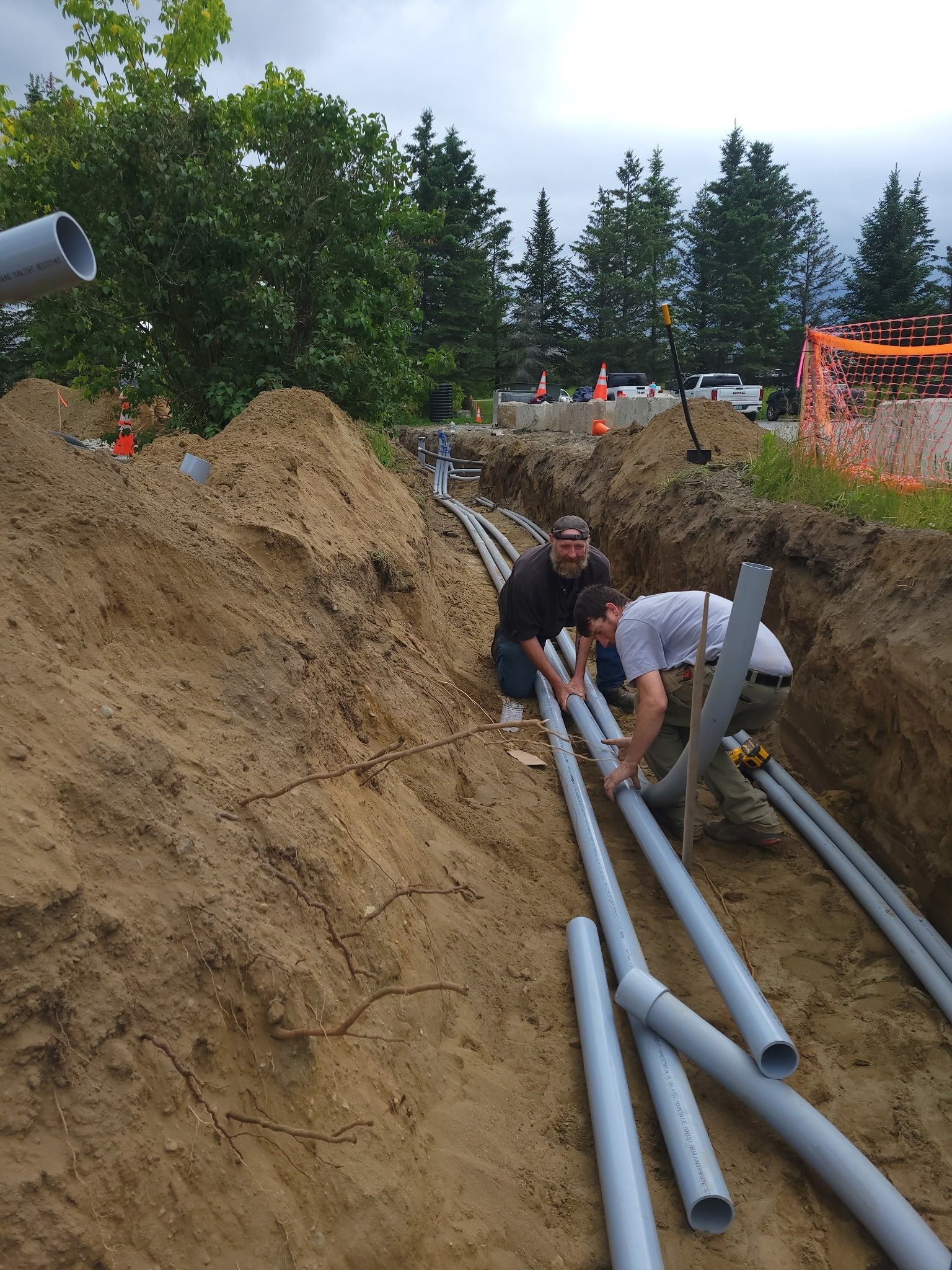 Electricians installing conduit